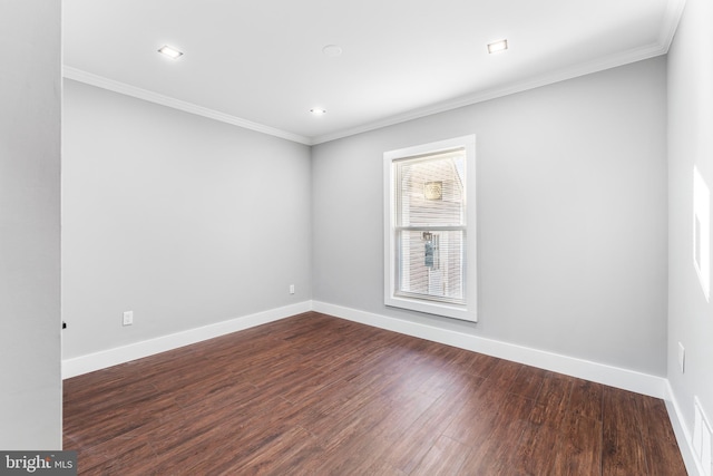 empty room featuring crown molding and dark hardwood / wood-style floors