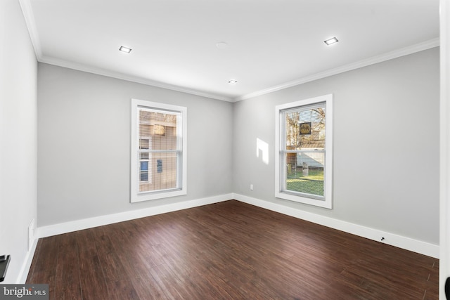 empty room featuring hardwood / wood-style floors and ornamental molding