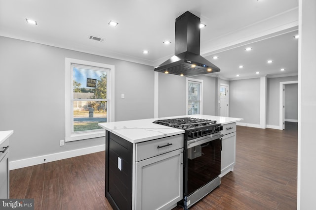 kitchen with island exhaust hood, light stone countertops, dark wood-type flooring, a kitchen island, and stainless steel range with gas stovetop