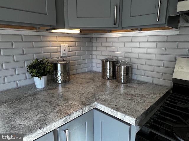 kitchen featuring gray cabinetry and stove