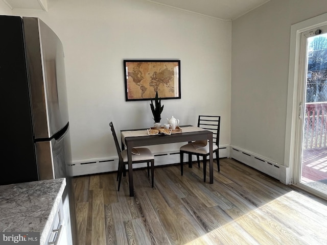 dining area featuring hardwood / wood-style flooring and a baseboard radiator