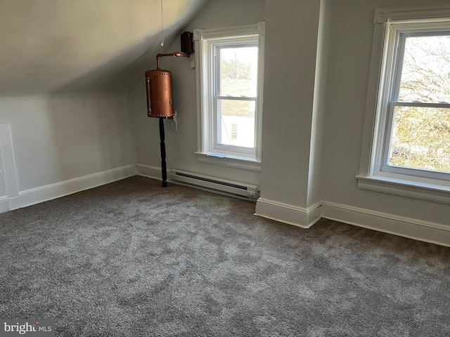 bonus room featuring dark colored carpet, vaulted ceiling, and a baseboard heating unit