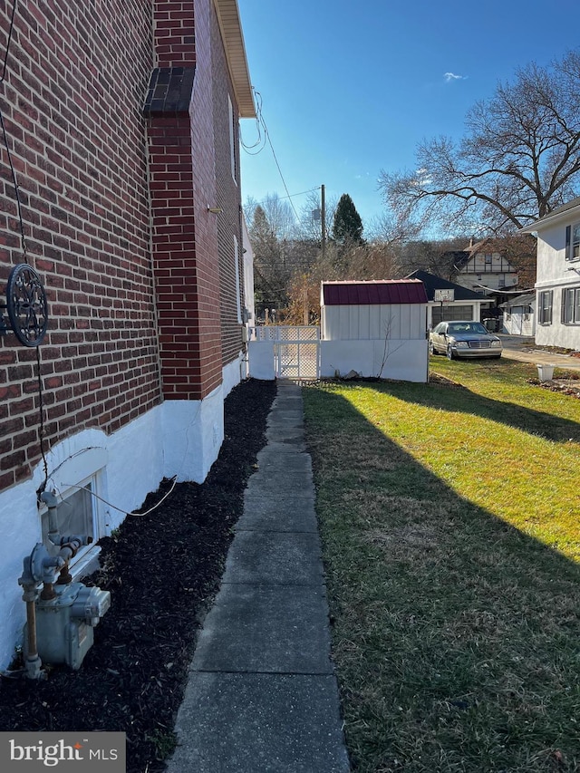 view of home's exterior with a yard and a shed