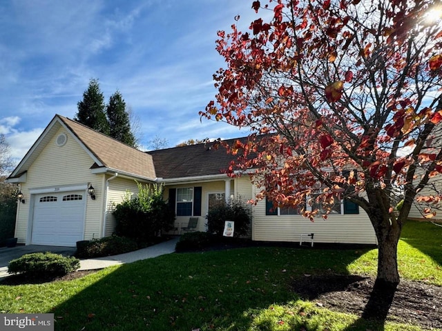 view of front of house featuring a garage and a front yard