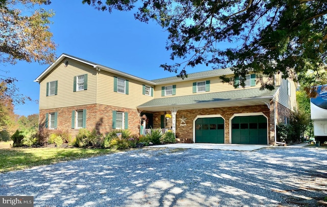 220 Robinson Rd, Salem, NJ 08079 - view of front facade with brick siding, covered porch, a garage, and driveway