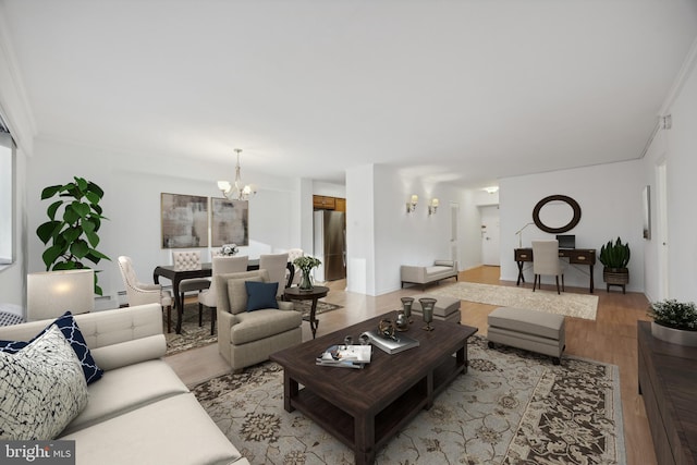 living room with a chandelier, light hardwood / wood-style floors, and crown molding