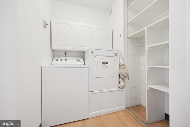 1900 John F Kennedy Unit 2002, Philadelphia, PA 19103 - washroom with cabinet space, separate washer and dryer, and light wood finished floors