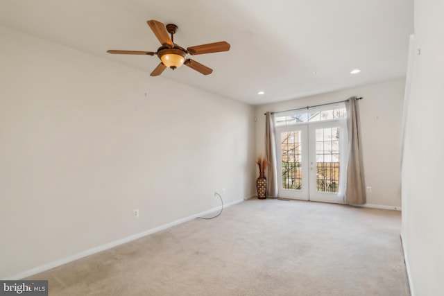 carpeted empty room featuring ceiling fan and french doors