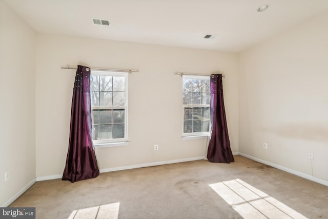 empty room featuring light colored carpet