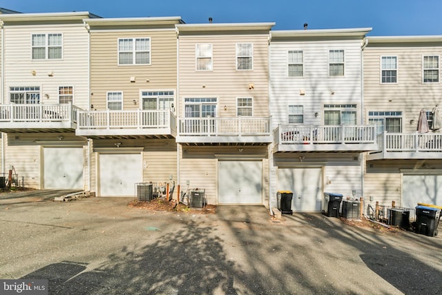 rear view of property featuring central AC unit