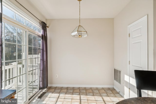 unfurnished dining area featuring light tile patterned floors