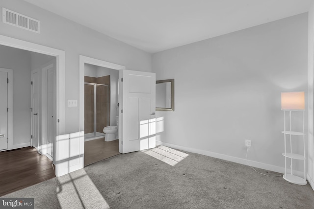 unfurnished bedroom featuring carpet and connected bathroom