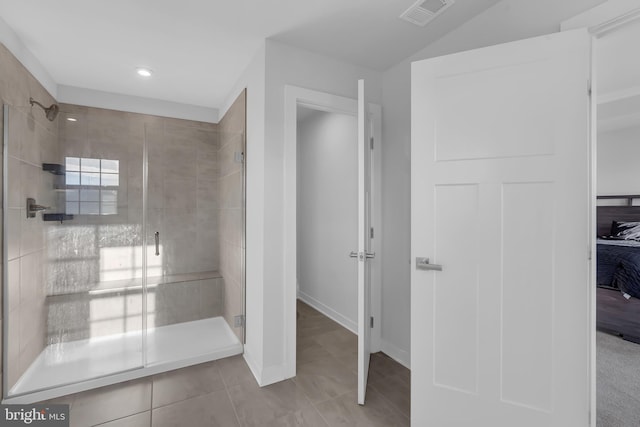 bathroom with tile patterned floors and a shower with shower door