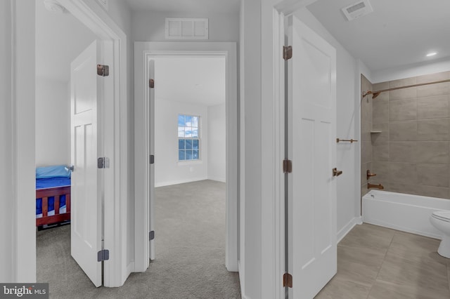 hallway featuring light colored carpet