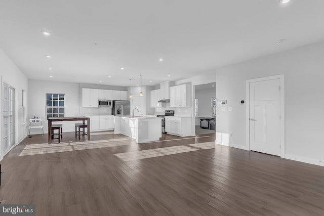 unfurnished living room with sink and dark wood-type flooring