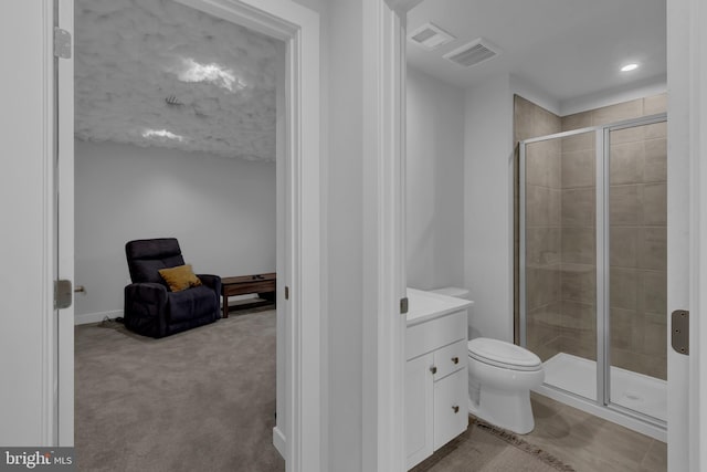 bathroom with vanity, toilet, and a shower with shower door