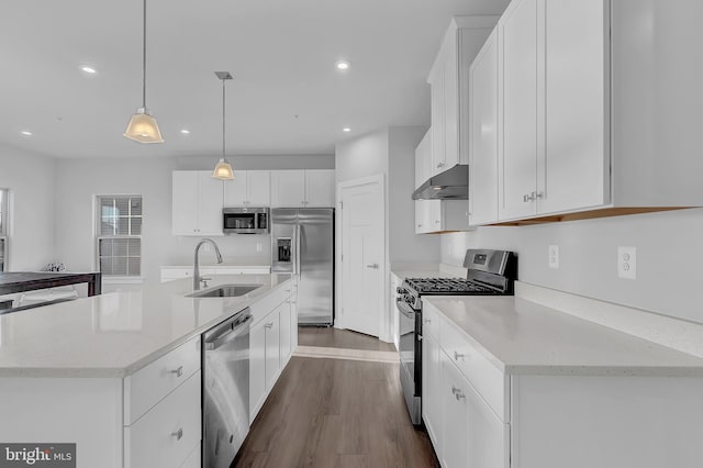 kitchen with white cabinetry, sink, hanging light fixtures, an island with sink, and appliances with stainless steel finishes