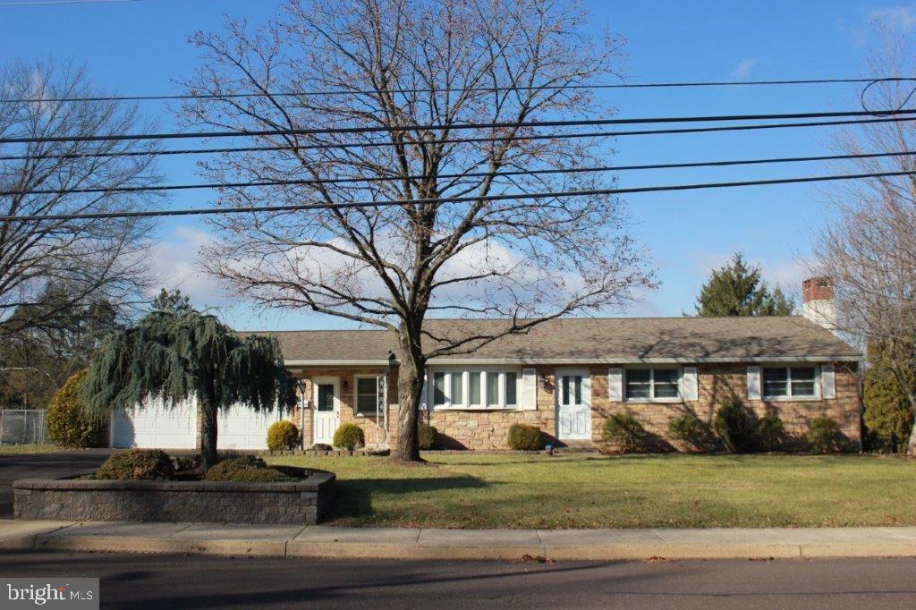 single story home with a front yard and a garage