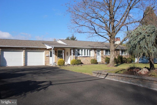 single story home with a front yard and a garage