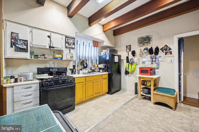 5122 N Broad St, Philadelphia, PA 19141 - kitchen featuring beam ceiling, white cabinetry, sink, and black appliances