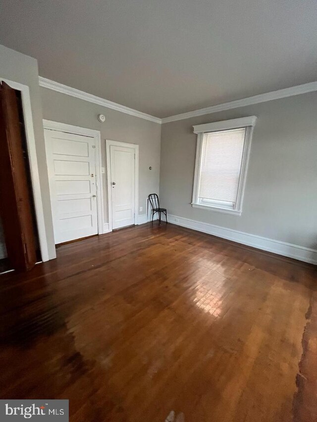 5122 N Broad St, Philadelphia, PA 19141 - spare room featuring ornamental molding and dark wood-type flooring