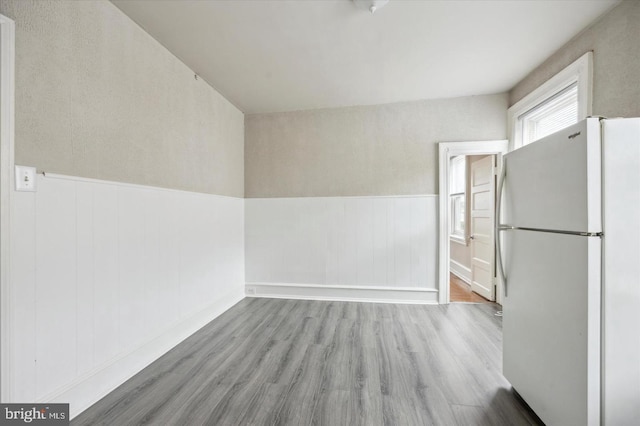 kitchen featuring light wood-type flooring and white fridge