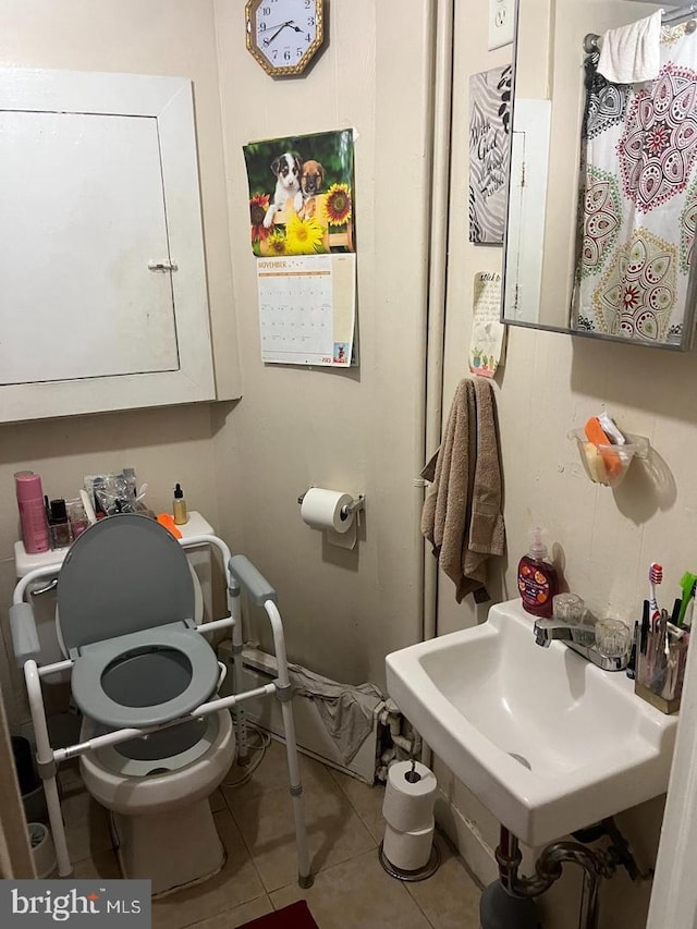 5122 N Broad St, Philadelphia, PA 19141 - bathroom with tile patterned floors, toilet, and sink