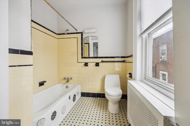 5122 N Broad St, Philadelphia, PA 19141 - bathroom featuring radiator heating unit, shower / bath combination, tile walls, and toilet