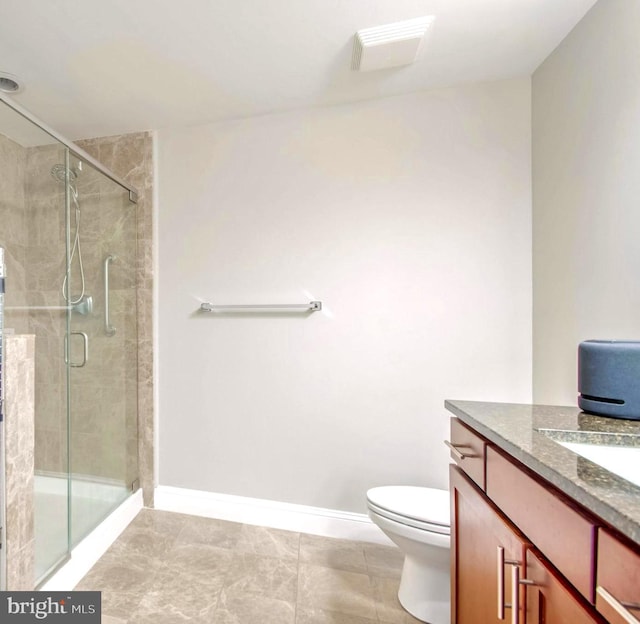 bathroom with tile patterned floors, vanity, toilet, and an enclosed shower