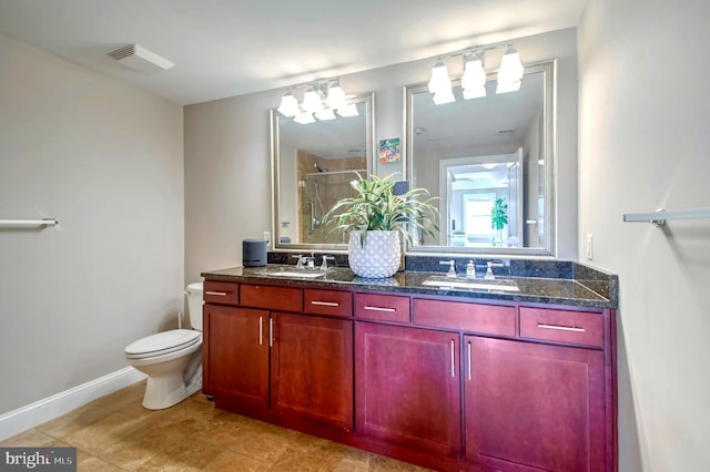 bathroom featuring tile patterned flooring, vanity, toilet, and a shower