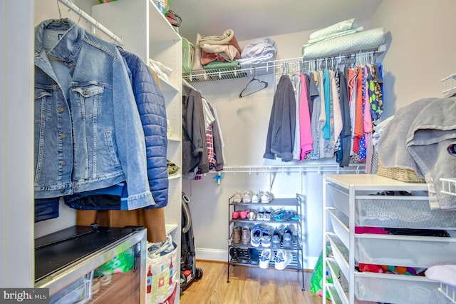 walk in closet featuring light hardwood / wood-style flooring