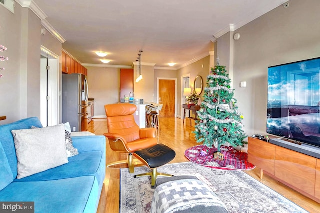 living room with light hardwood / wood-style floors and ornamental molding