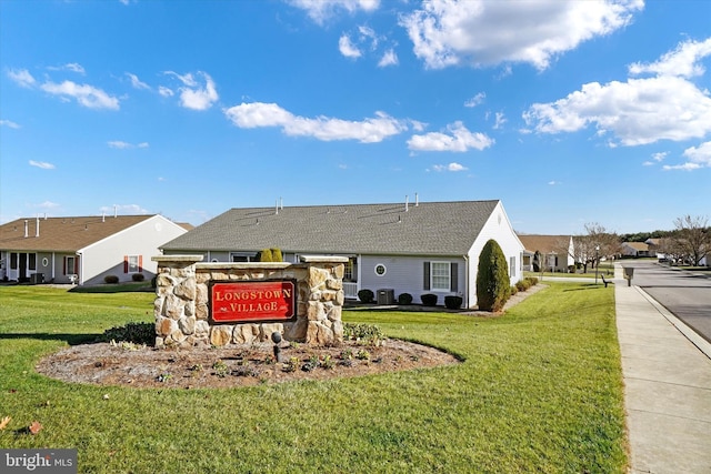 community sign featuring a yard