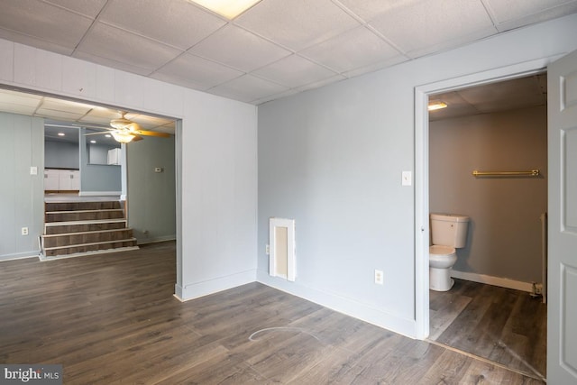 unfurnished room featuring a paneled ceiling, dark hardwood / wood-style floors, and ceiling fan