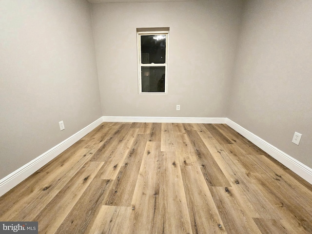 spare room with hardwood / wood-style flooring