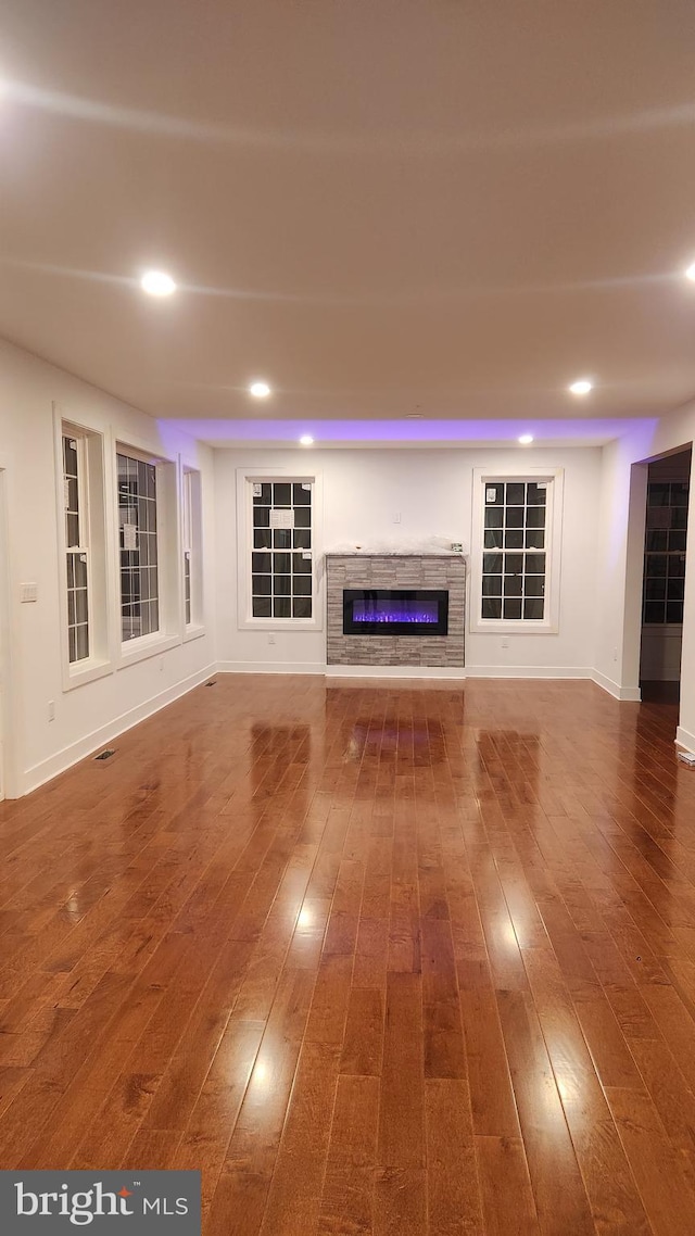 unfurnished living room with dark wood-type flooring