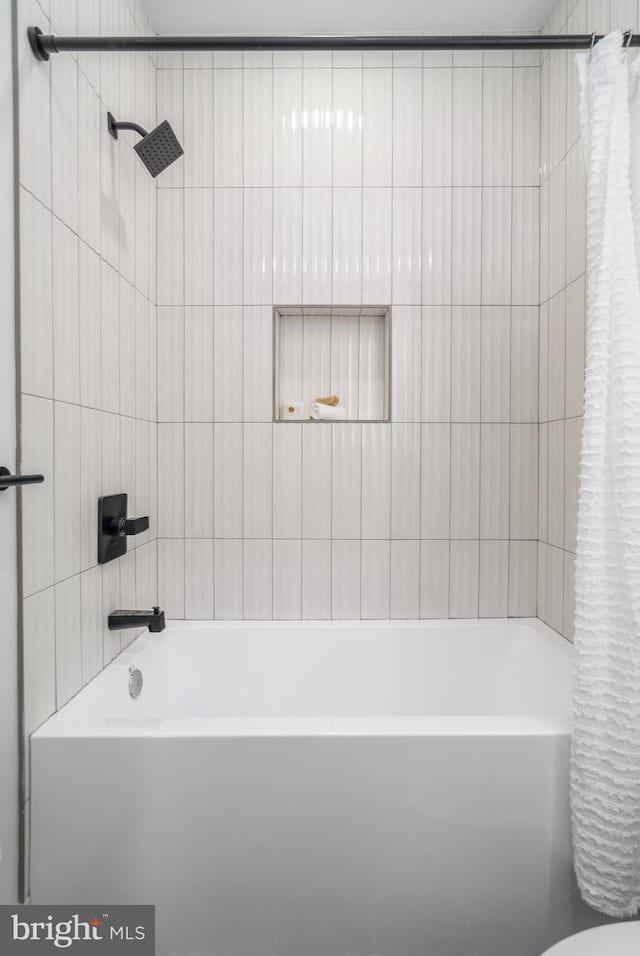 bathroom with shower / bath combo and toilet