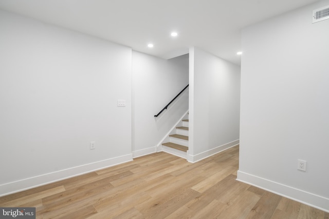 basement with light hardwood / wood-style floors