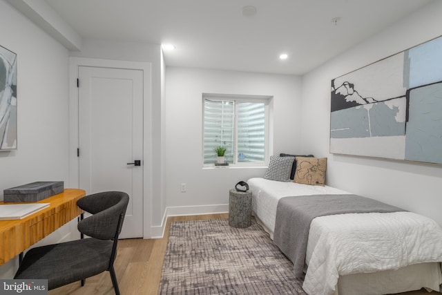 bedroom with hardwood / wood-style floors