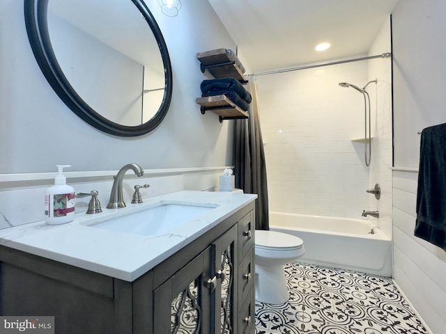 full bathroom featuring tile patterned flooring, vanity, toilet, and tiled shower / bath combo