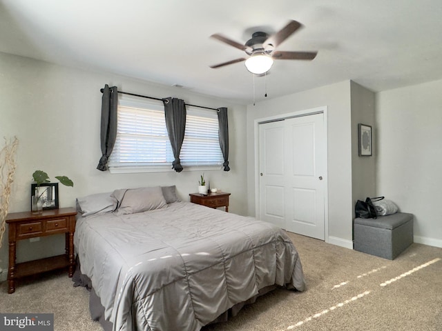 bedroom featuring light carpet, a closet, and ceiling fan