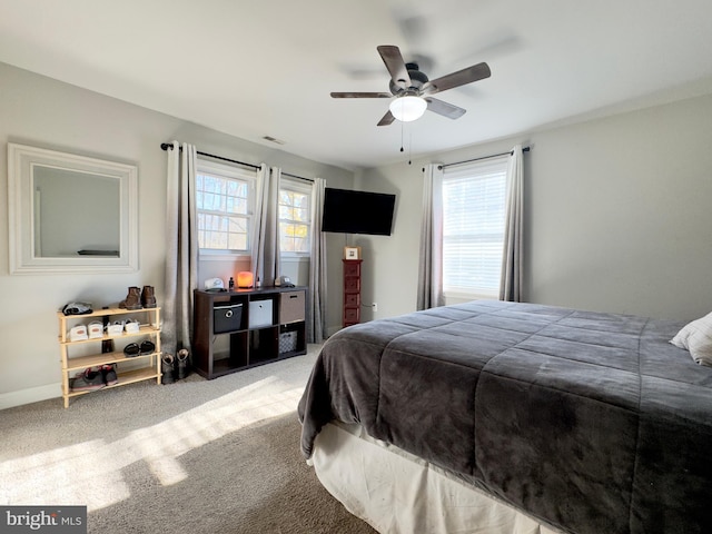 bedroom with carpet, multiple windows, and ceiling fan