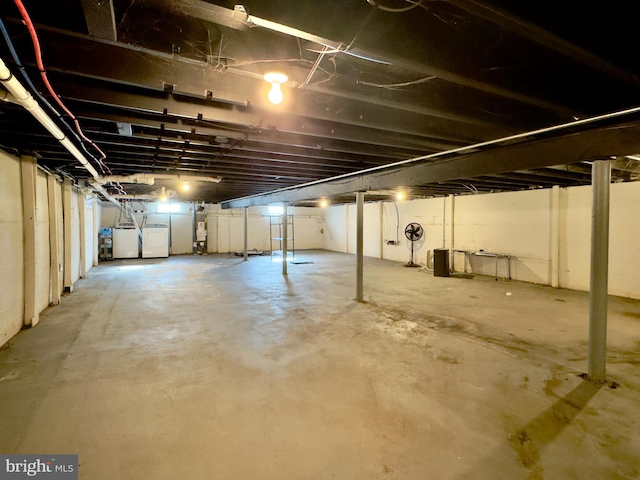 basement with gas water heater and separate washer and dryer