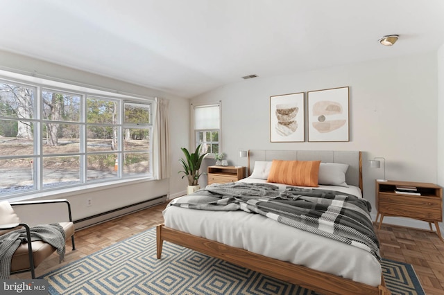 bedroom with multiple windows, a baseboard radiator, and parquet flooring