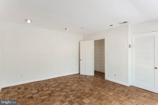 unfurnished room with dark parquet floors