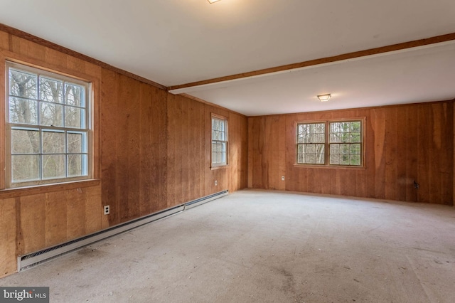 unfurnished room with beam ceiling, a wealth of natural light, and a baseboard heating unit