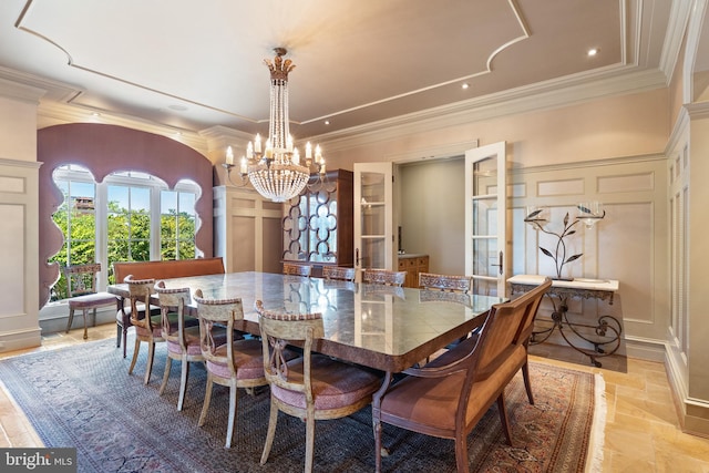 dining space featuring ornamental molding and a chandelier