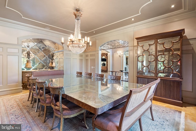 dining area featuring ornamental molding and a chandelier