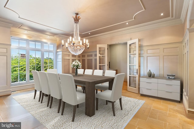 dining room featuring crown molding and a chandelier