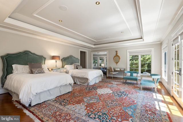 bedroom featuring french doors, wood-type flooring, crown molding, and a tray ceiling